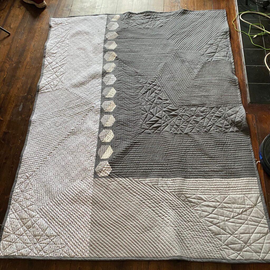grey-quilt-with-one-row-of-blocks