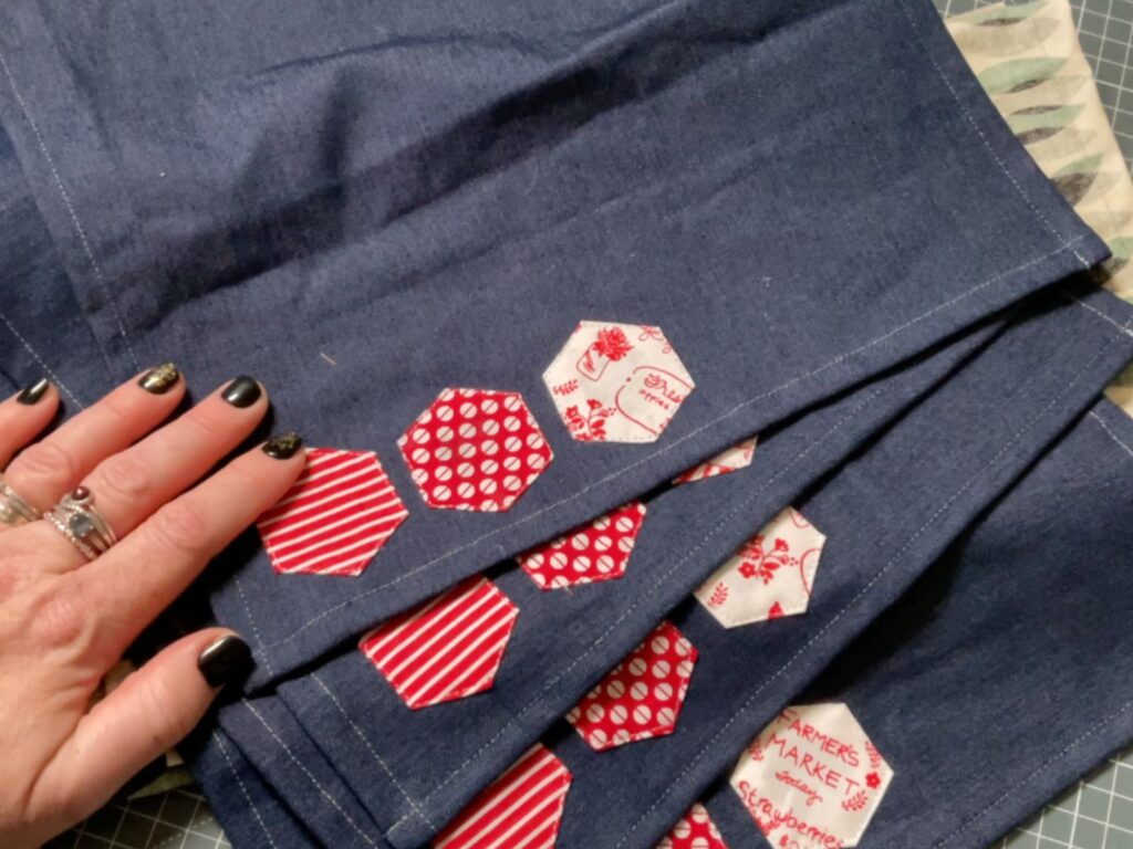 English paper pieced hexagons on a denim napkin
