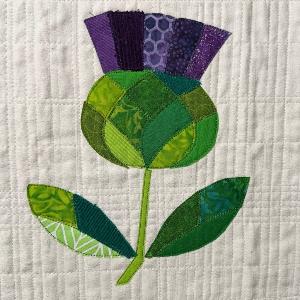 thistle collage on quilted background